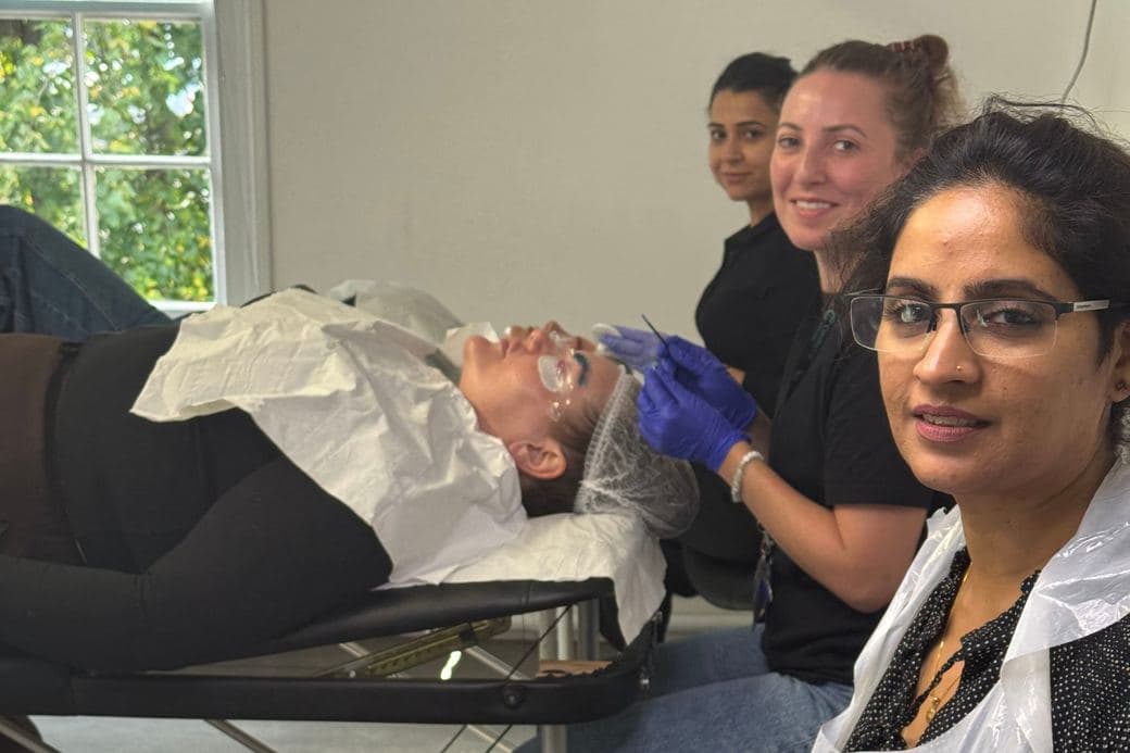 Learners practising a treatment with their tutor on a real model